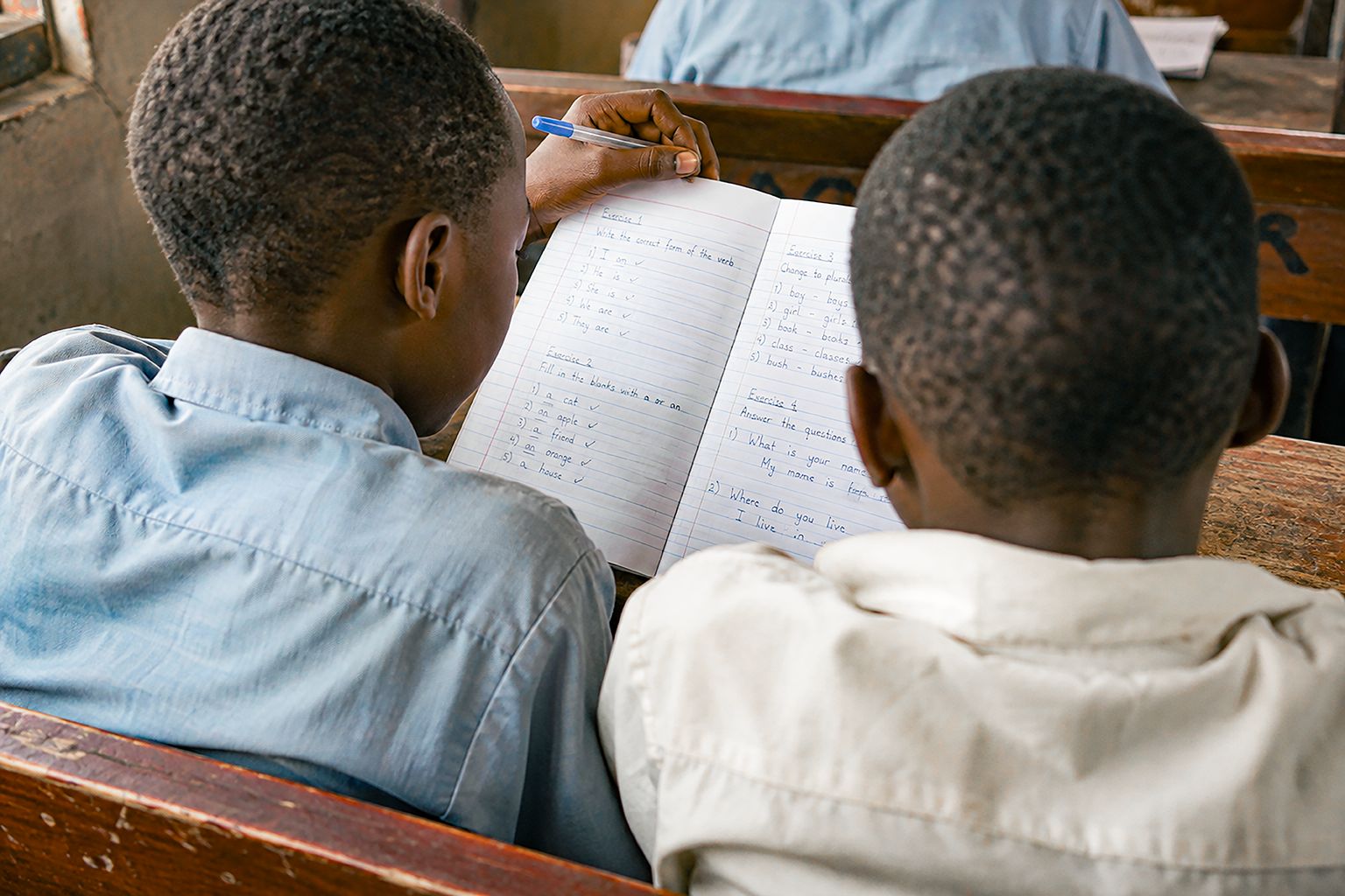 Ghanaian pupils writing in their notebooks